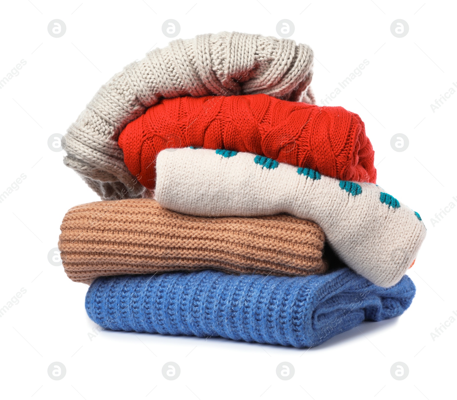 Photo of Stack of folded knitted sweaters on white background