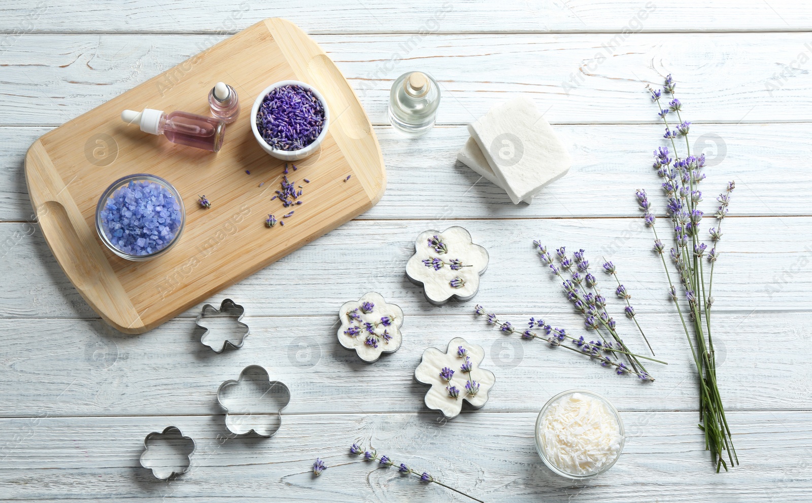 Photo of Flat lay composition of handmade soap bars with lavender flowers and ingredients on white wooden background