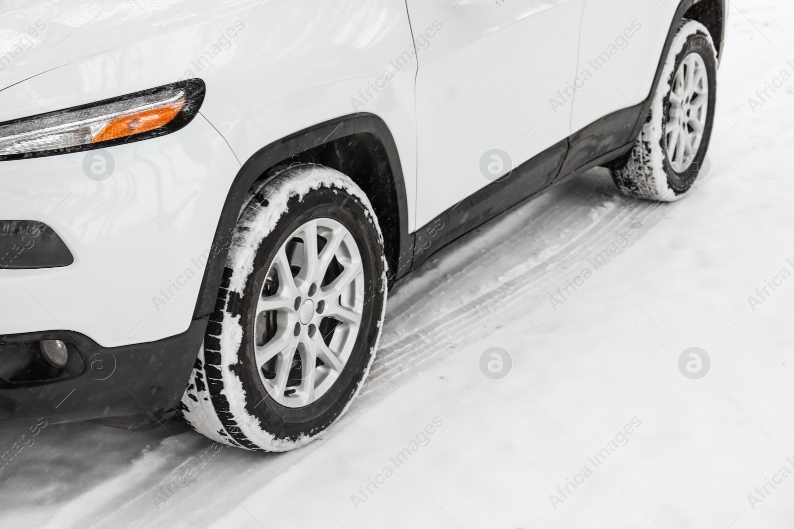 Photo of Modern car on snowy road, closeup view. Winter season