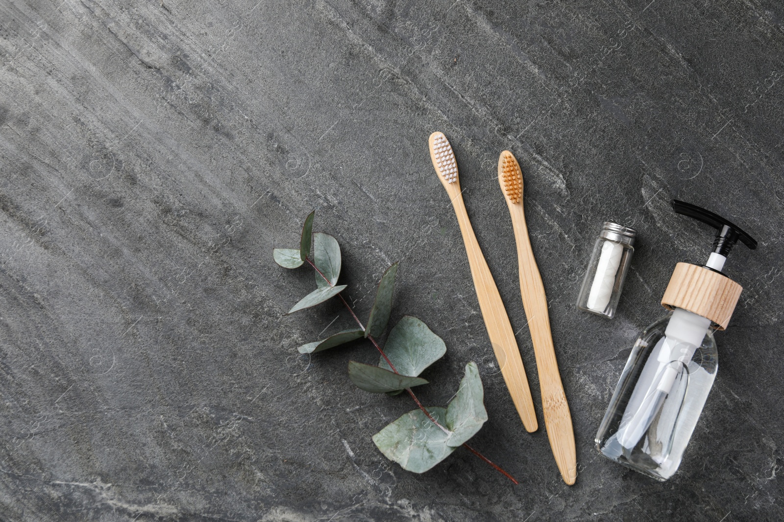 Photo of Flat lay composition with bamboo toothbrushes on black table, space for text