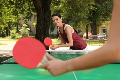 Photo of Young women playing ping pong in park
