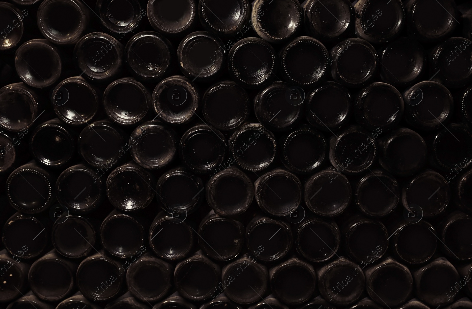 Photo of Bottoms of wine bottles as background, closeup