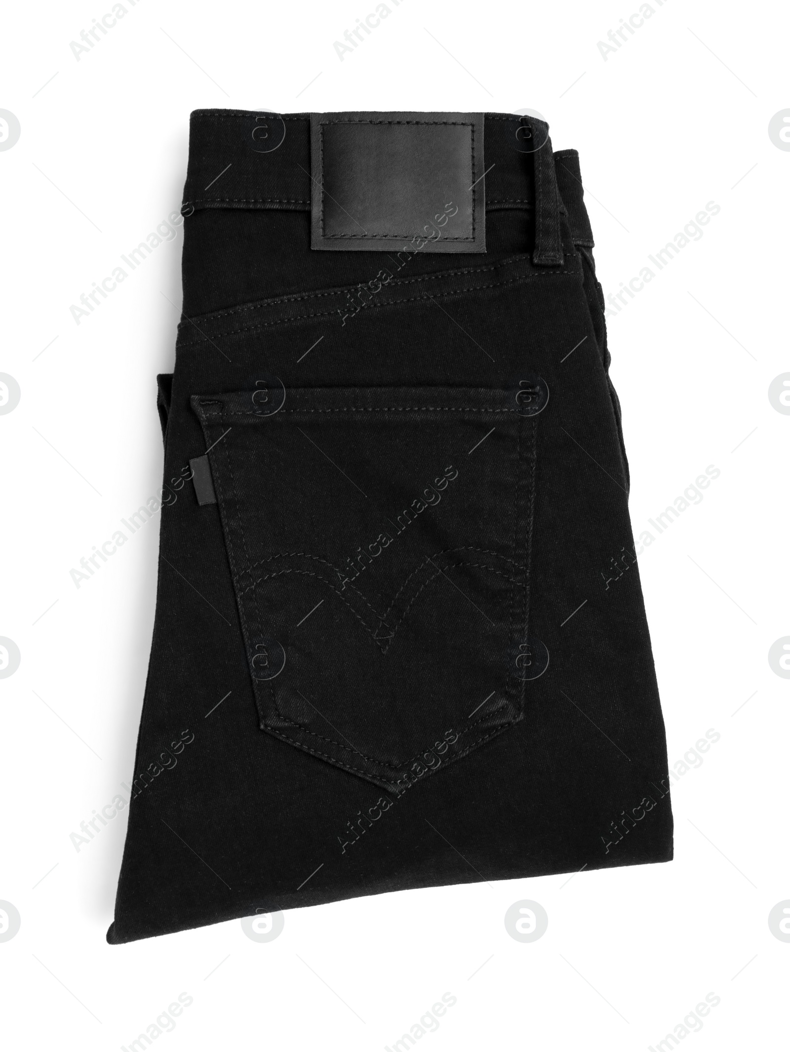 Photo of Folded black jeans isolated on white, top view