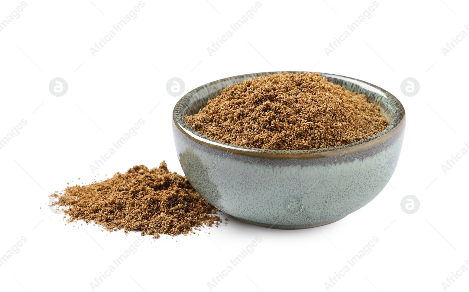 Photo of Bowl and aromatic caraway (Persian cumin) powder isolated on white