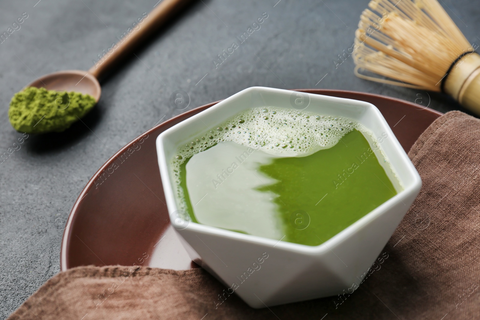 Photo of Chawan with fresh matcha tea on table