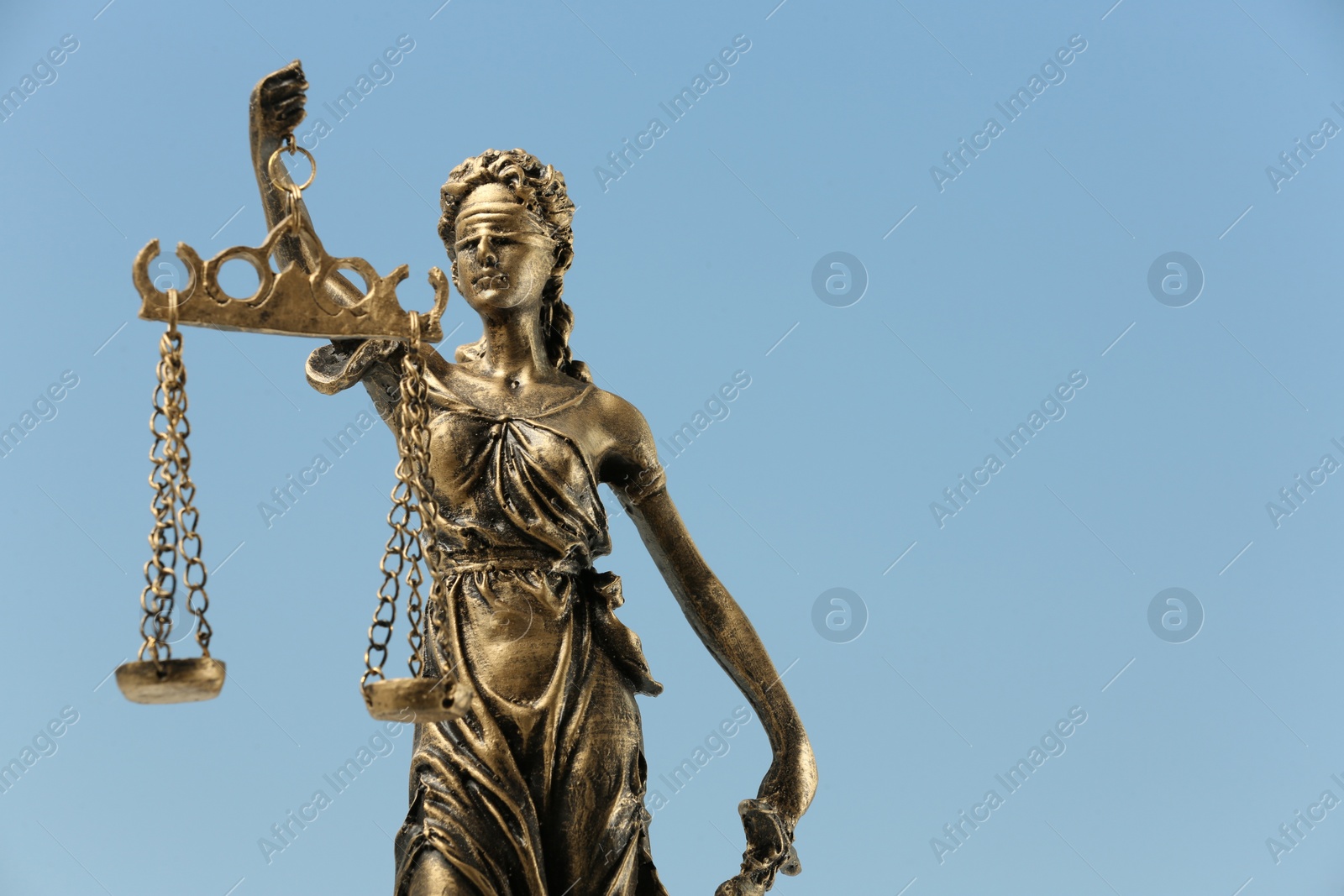 Photo of Symbol of fair treatment under law. Figure of Lady Justice against sky, closeup with space for text