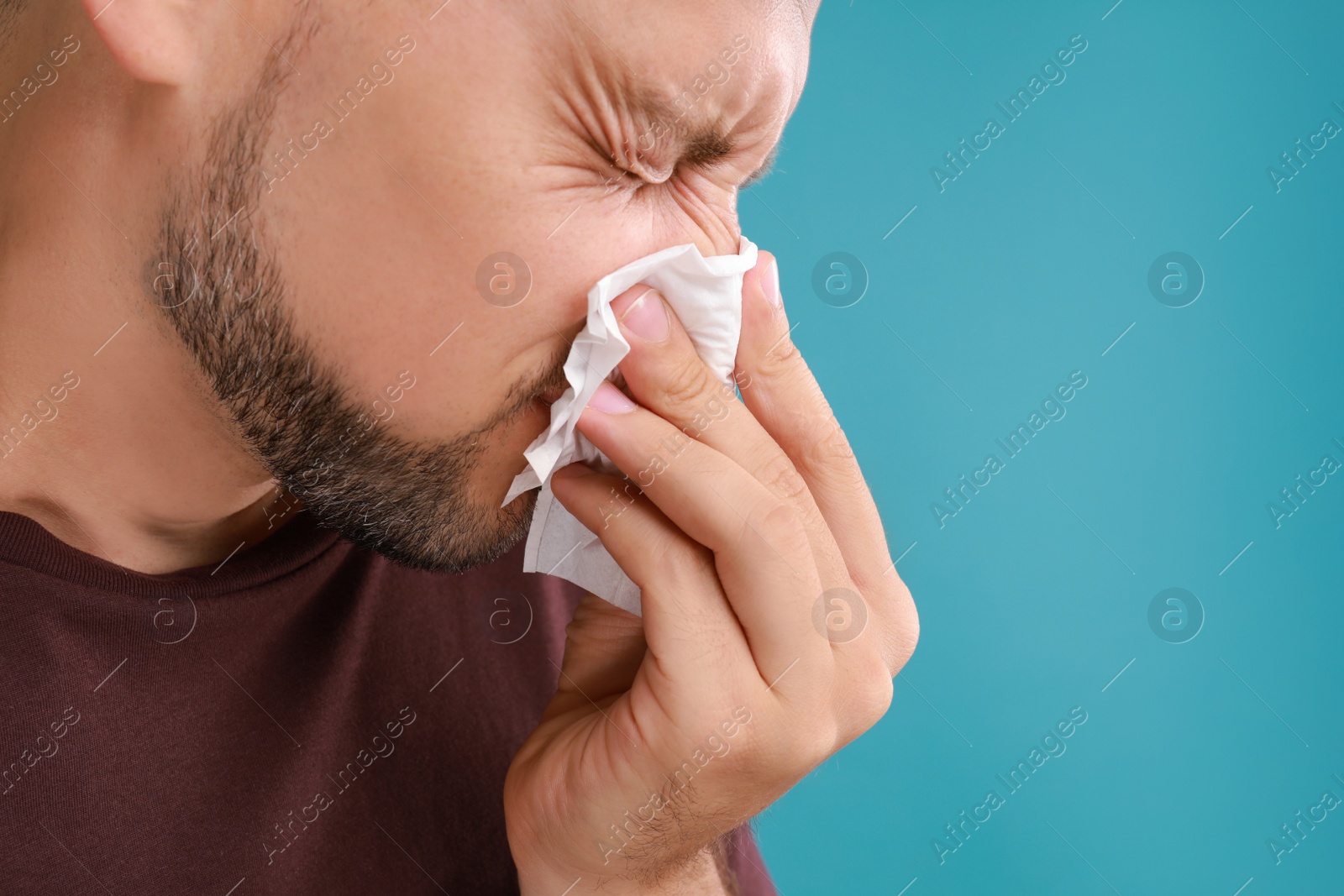 Photo of Man suffering from allergy on blue background. Space for text