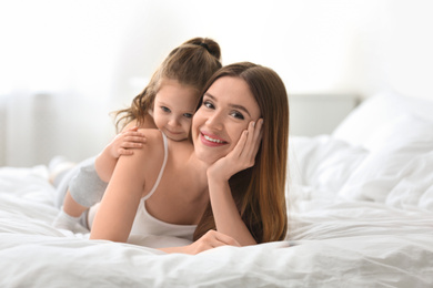 Photo of Happy mother with little daughter in bedroom