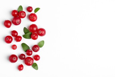 Photo of Fresh ripe cranberries and green leaves on white background, flat lay. Space for text