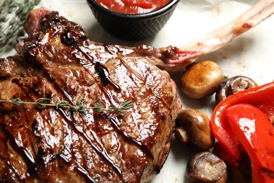 Photo of Delicious grilled ribeye with garnish, closeup view