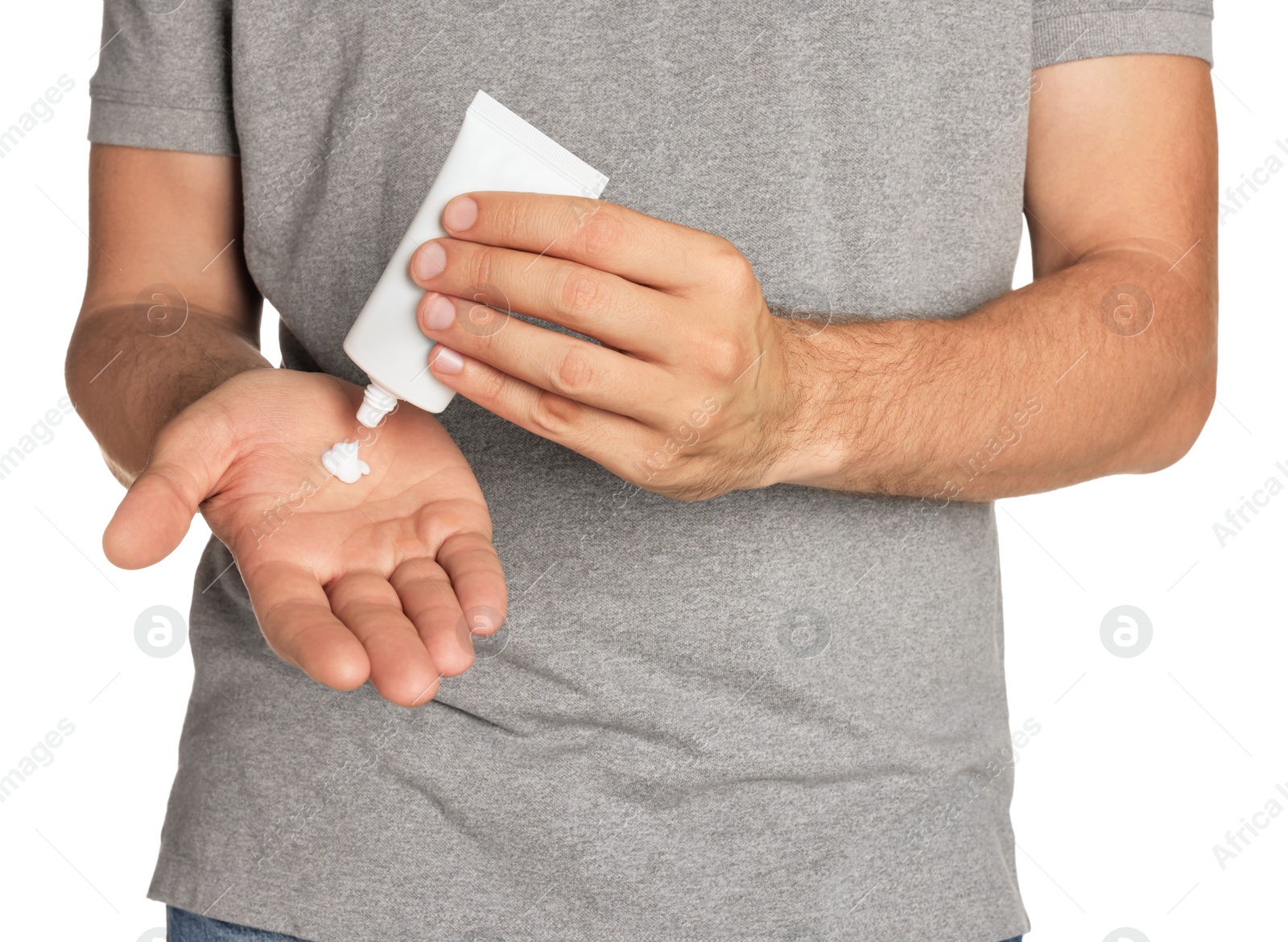 Photo of Man applying cream from tube onto hand on white background, closeup