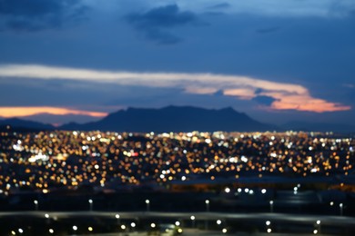 Blurred view of cityscape and mountains, bokeh effect