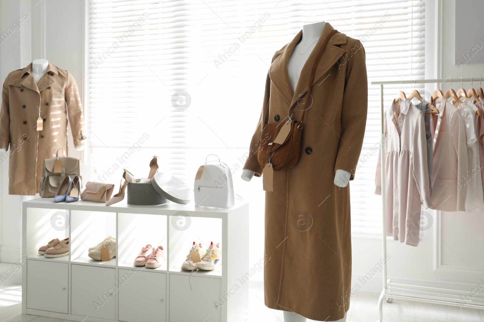 Photo of Collectionstylish women's clothes, shoes and accessories in modern boutique