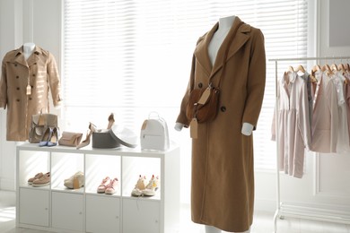 Photo of Collection of stylish women's clothes, shoes and accessories in modern boutique