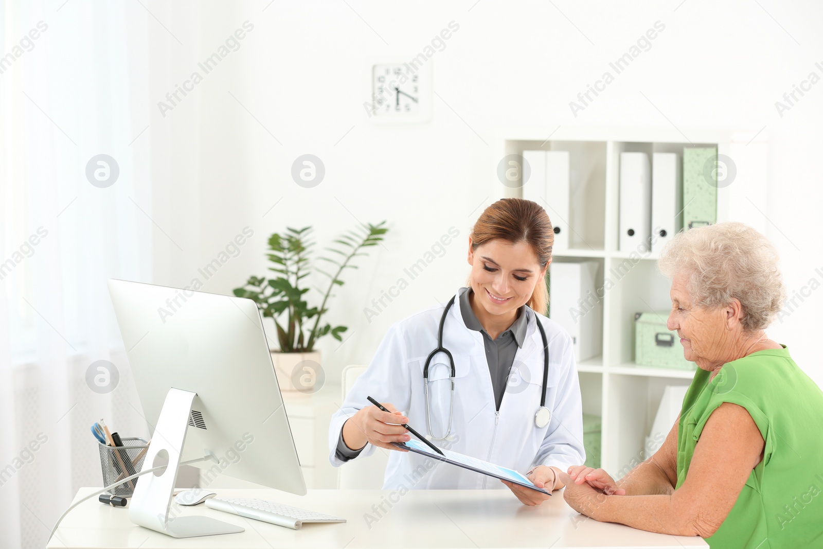 Photo of Doctor working with elderly patient in hospital