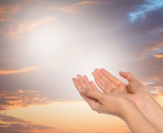 Image of Religion. Christian woman praying against sky, closeup