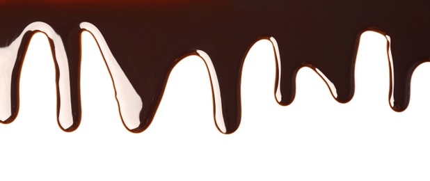 Photo of Delicious melted chocolate flowing on white background