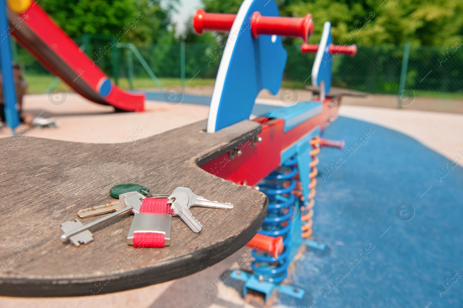 Photo of Keys forgotten on seat of spring rider at playground. Lost and found