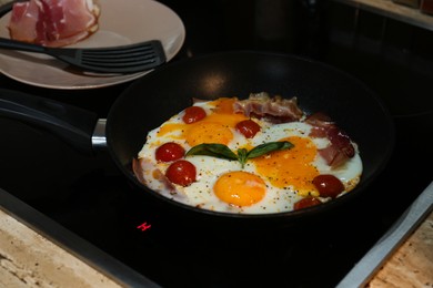 Photo of Tasty fried eggs with tomatoes and bacon for breakfast