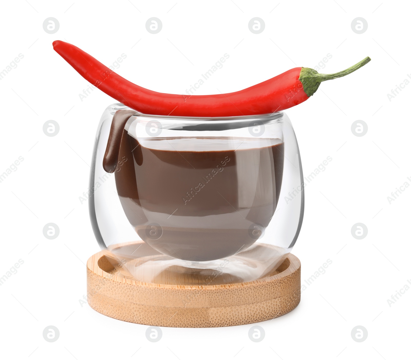 Photo of Glass of hot chocolate with chili pepper on white background