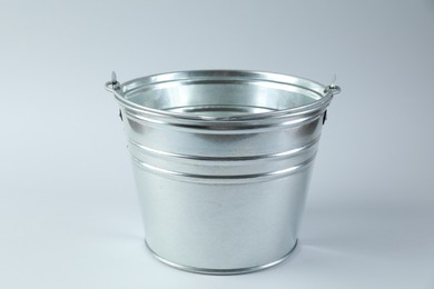 Photo of One shiny metal bucket on white background