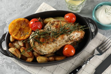 Photo of Tasty chicken, vegetables, drink with tarragon and sour cream served on grey table, flat lay