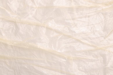 Crumpled yellow plastic bag as background, top view