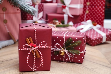 Different beautiful Christmas gifts on floor indoors