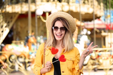 Beautiful woman with candies having fun at amusement park