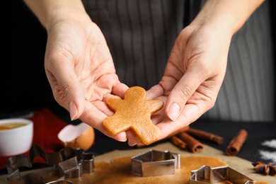 Photo of Woman making Christmas cookies at table, closeup