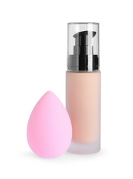 Photo of Bottle of skin foundation and sponge on white background. Makeup product