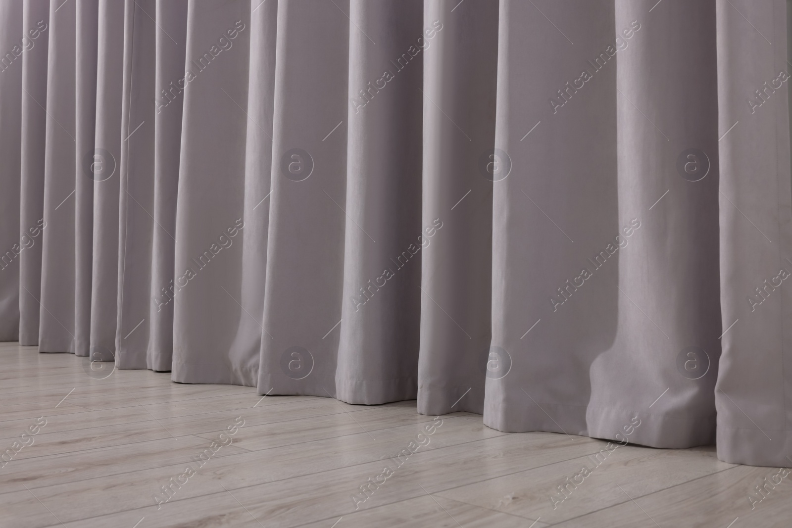 Photo of Light grey window curtains in living room, closeup