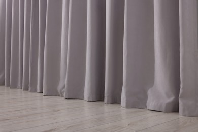 Light grey window curtains in living room, closeup