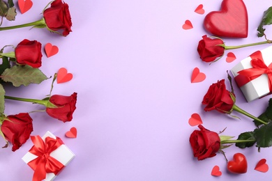 Photo of Flat lay composition with beautiful red roses and gift boxes on violet background, space for text. Valentine's Day celebration