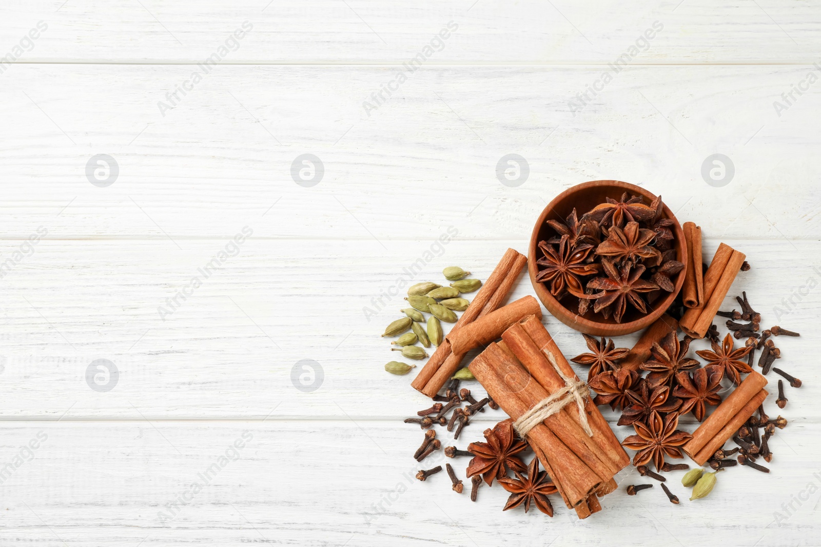 Photo of Flat lay composition with mulled wine ingredients on white wooden table. Space for text