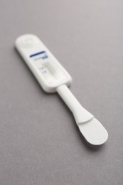 Photo of Disposable express test on light grey background, closeup