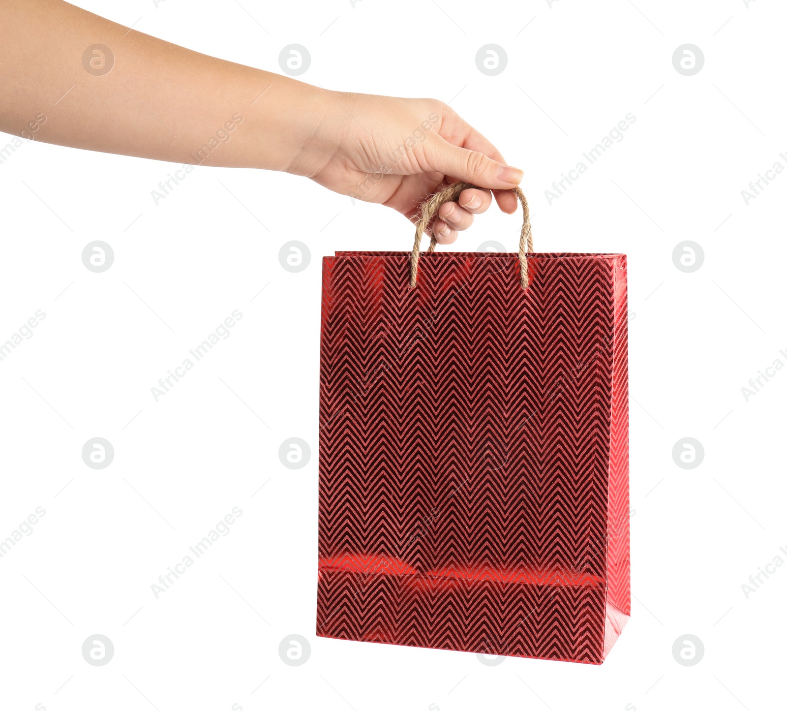 Photo of Woman holding red paper shopping bag on white background, closeup. Space for design