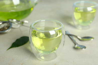 Photo of Fresh aromatic green tea on light table