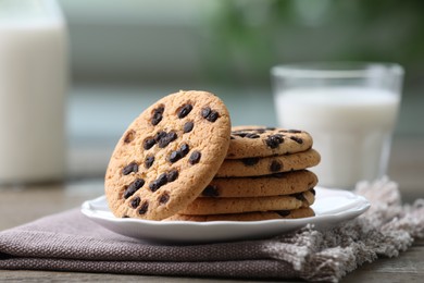 Photo of Delicious chocolate chip cookies on wooden table, closeup