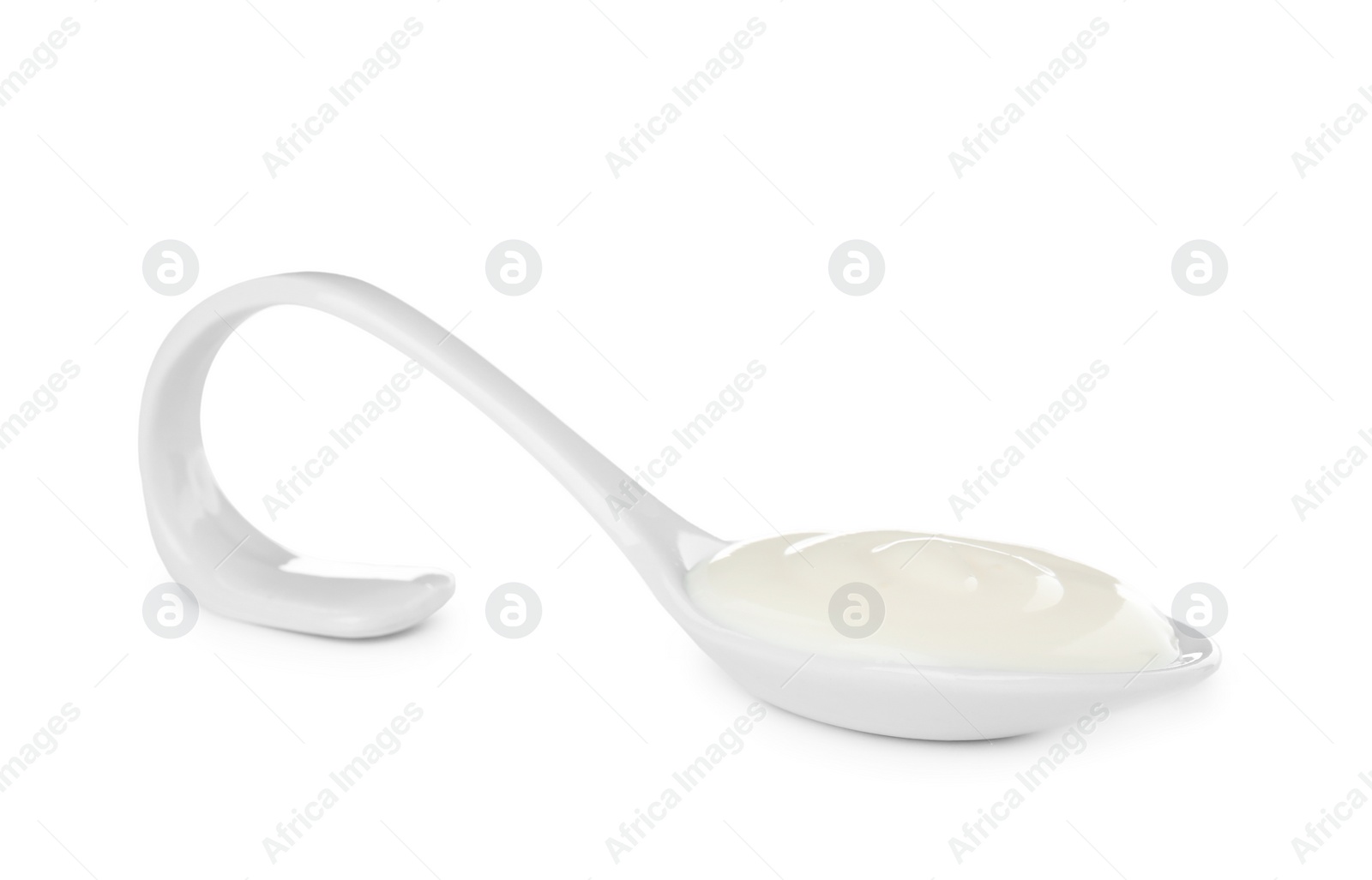 Photo of Serving spoon with sour cream on white background