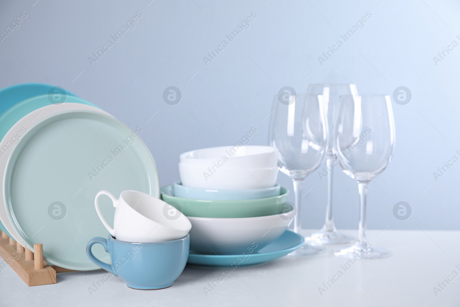 Photo of Set of clean tableware on light table