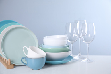 Photo of Set of clean tableware on light table