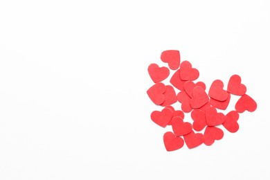 Photo of Paper hearts on white background, top view. Space for text