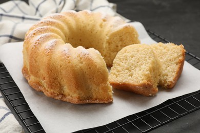 Photo of Delicious freshly baked sponge cake on black table, closeup