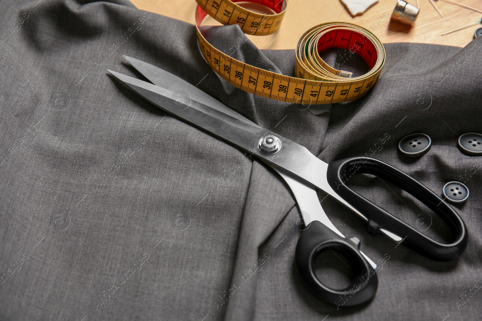 Photo of Composition with fabric and accessories for tailoring on table