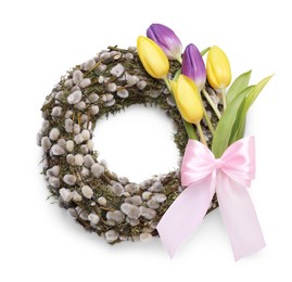 Wreath made of beautiful willow, colorful tulip flowers and pink bow on white background, top view