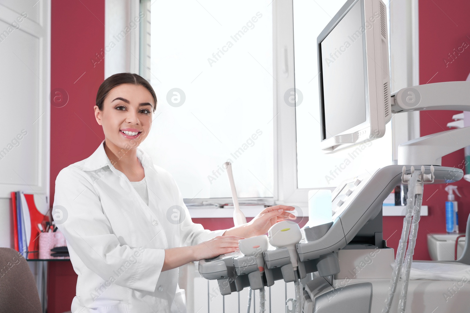 Photo of Sonographer using modern ultrasound machine in clinic