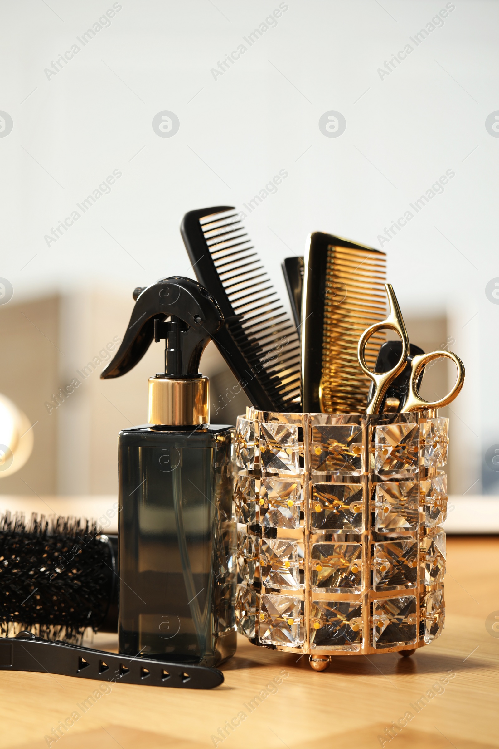 Photo of Set of hairdresser tools on table in salon