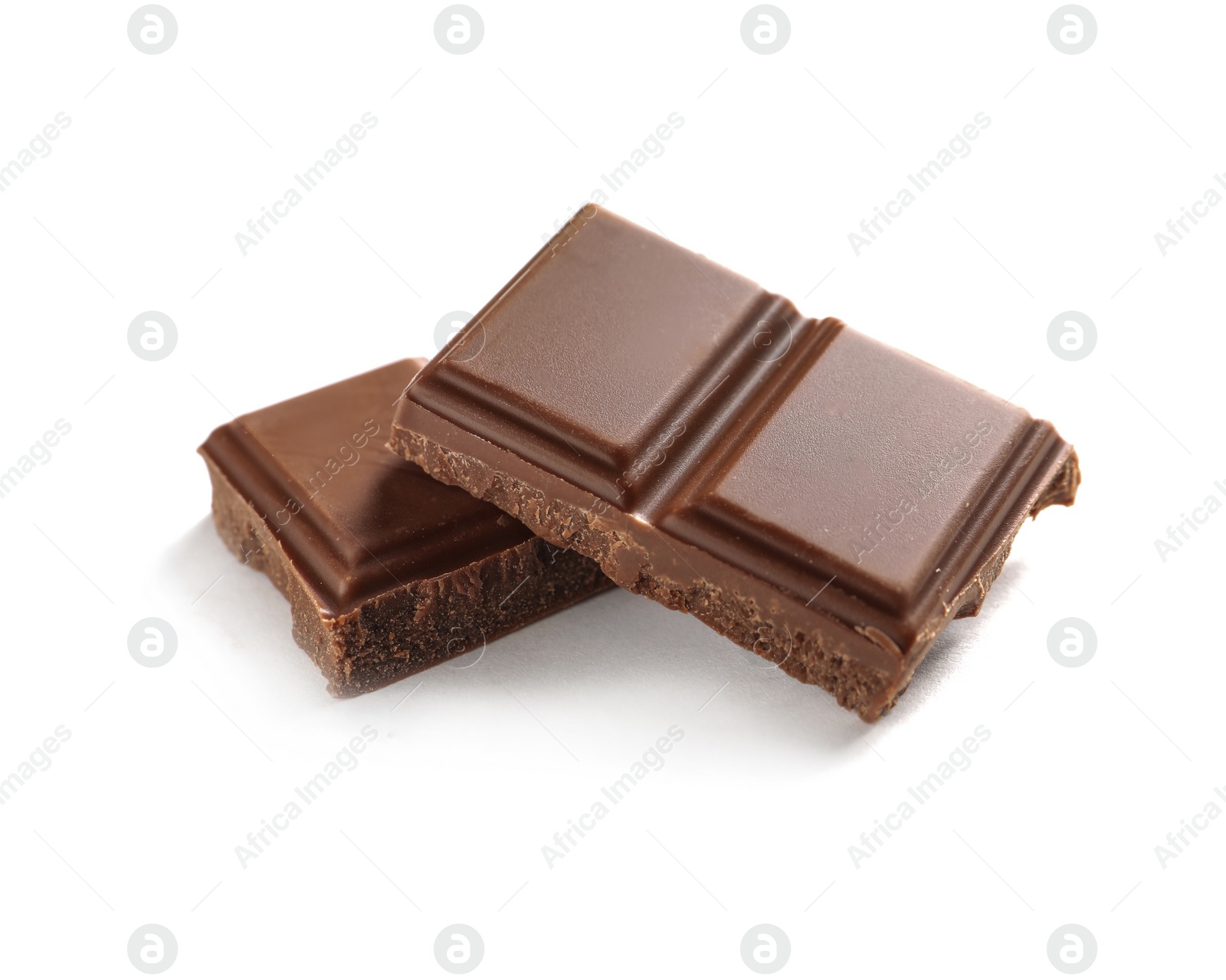 Photo of Pieces of tasty milk chocolate on white background