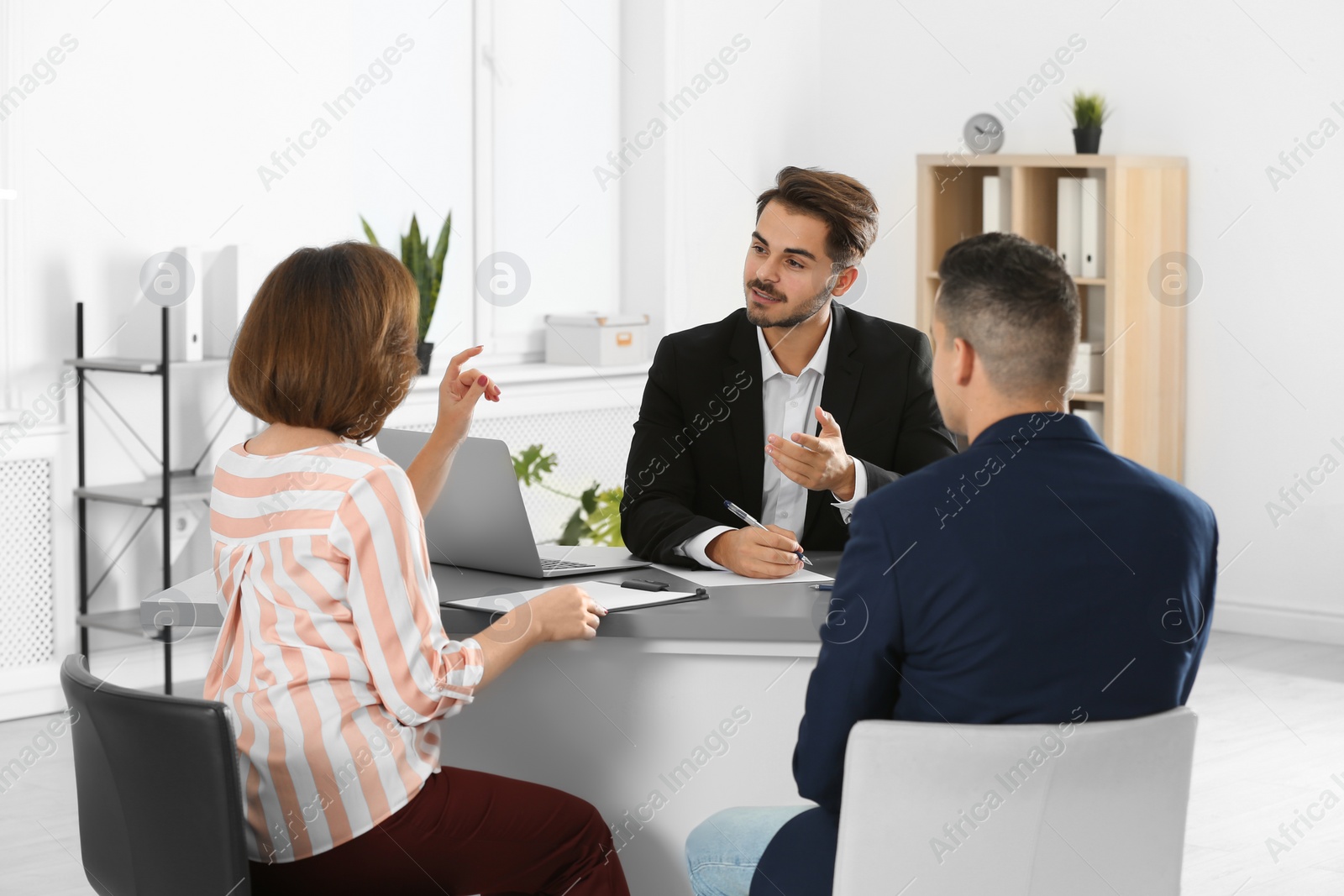 Photo of Human resources manager conducting job interview with applicants in office